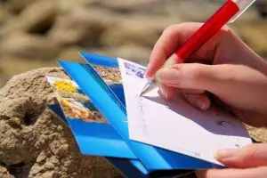 Writing postcard at the beach